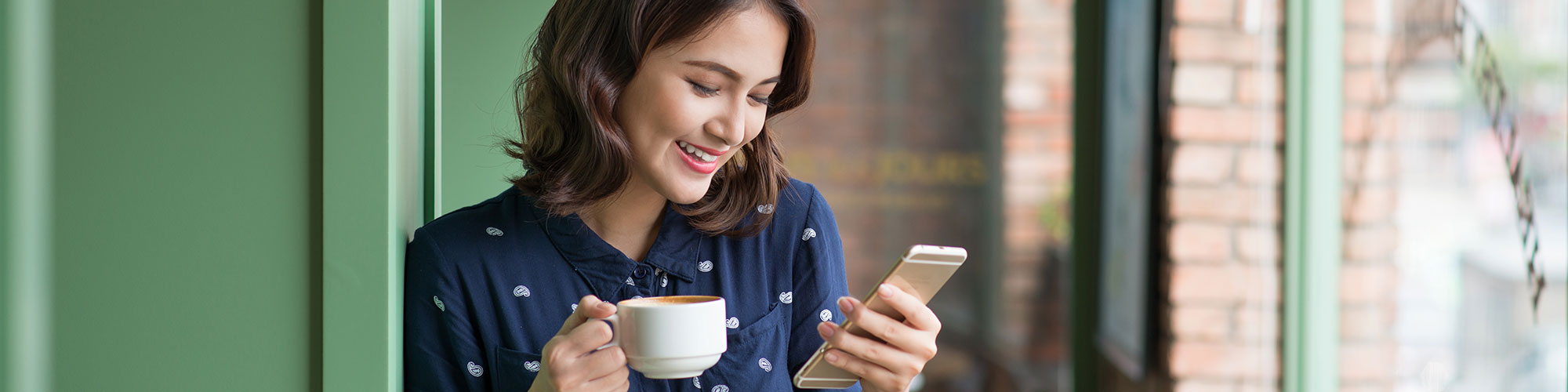 smiling woman looking a smartphone